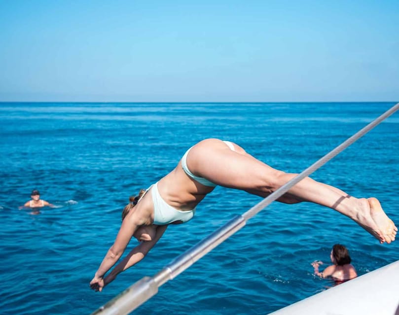 Malaga: Sailing Catamaran with Swimming and Paella Lunch - Leaving Malaga’s busy shore behind